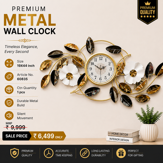 Black and gold floral vine metal wall clock, 19 x 44 inch, with white ginkgo blooms on a beige wall