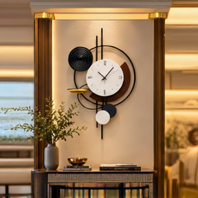 Black spiral and gold dish wall clock with offset black and white circles, 20 x 30 cm - styled in a hallway