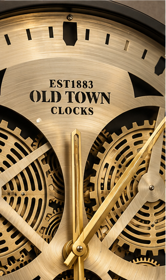 Brass gear wall clock with large exposed moving cogs and a black rim, 50 cm - close-up of the gear mechanism