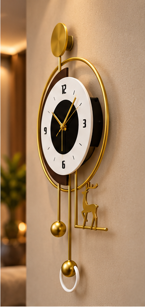 Gold deer pendulum wall clock with a black and white dial and gold ball pendulum, 20 x 30 cm - angled view on the wall