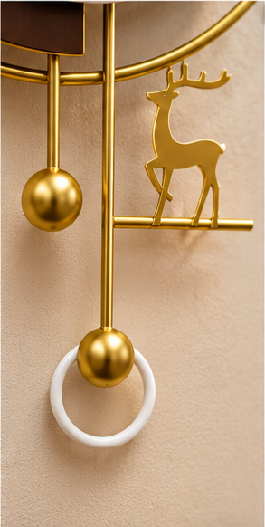 Gold deer pendulum wall clock with a black and white dial and gold ball pendulum, 20 x 30 cm - close-up of the gold deer and pendulum