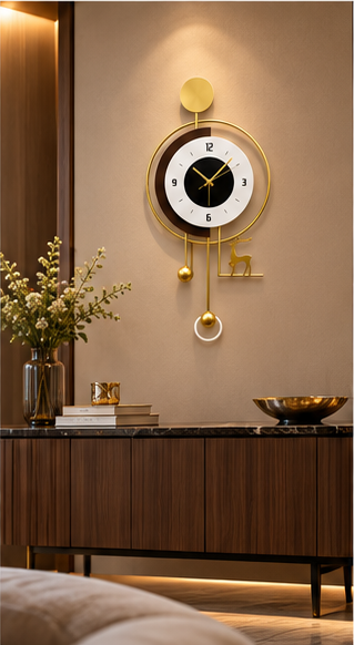 Gold deer pendulum wall clock with a black and white dial and gold ball pendulum, 20 x 30 cm - styled beside a sideboard
