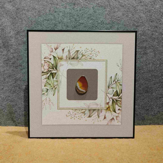 Nature's Gem: Framed Polished Stone with Floral Accents